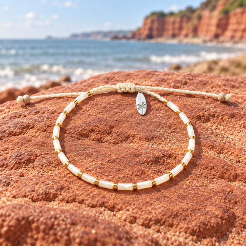 Womens Jewellery selection displayed on red sandstone beside the South Devon coast